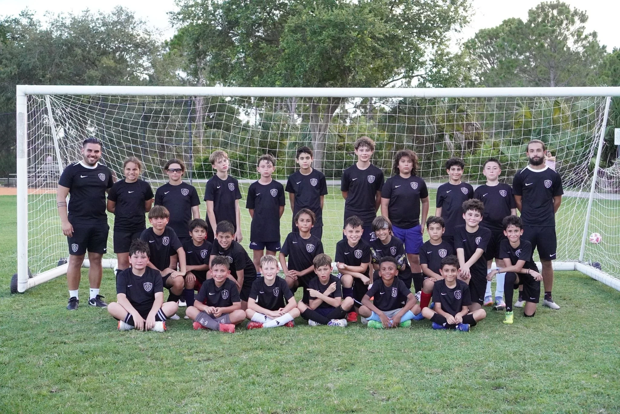 Players and coaches participating in the Top 1 Soccer Training summer soccer camp at Coral Reef Park in Miami, Florida.