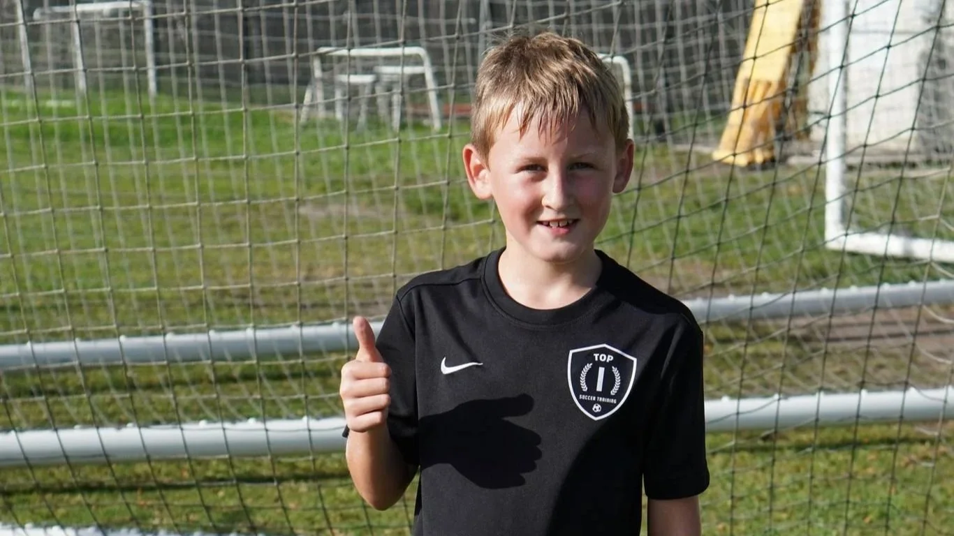 A soccer player having a fun time at Top 1 Soccer Training's Summer Camp & Clinic