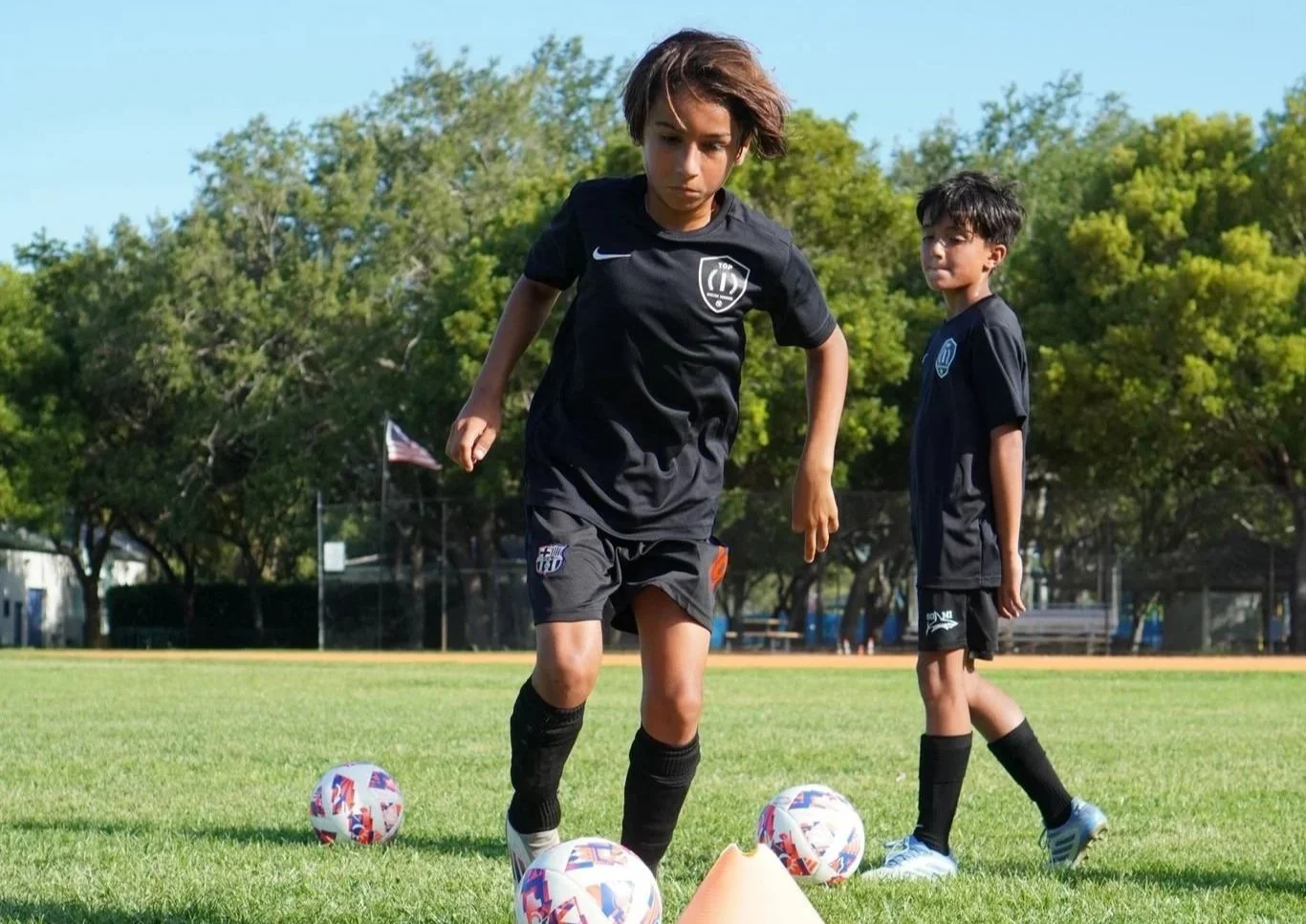 Players participating in a Top 1 Soccer Training summer soccer camp at Coral Reef Park