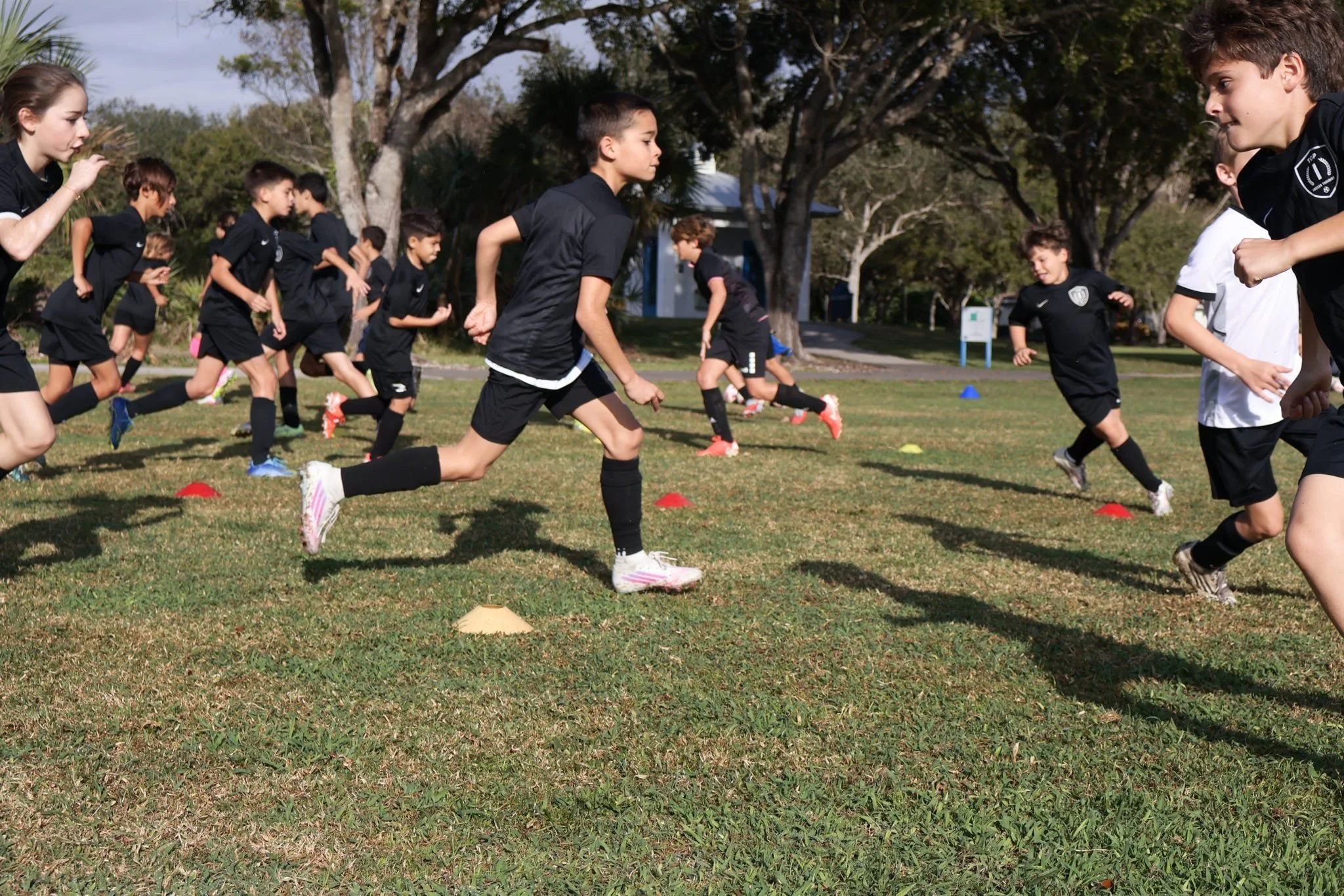 Players participating in a Top 1 Soccer Training summer soccer camp at Coral Reef Park