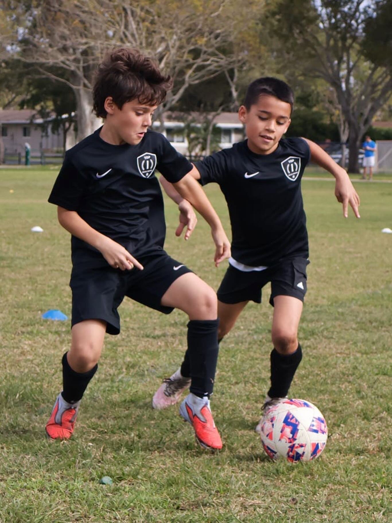 Players participating in a Top 1 Soccer Training summer soccer camp at Coral Reef Park