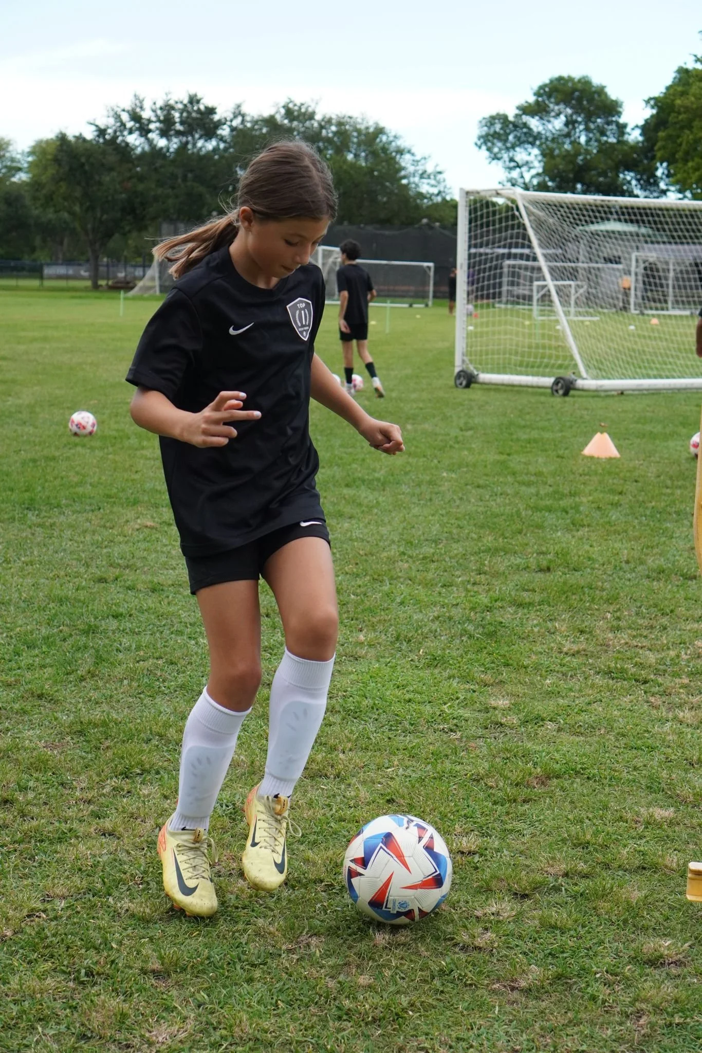 Youth athletes developing technical skills during a Top 1 Soccer Training clinic