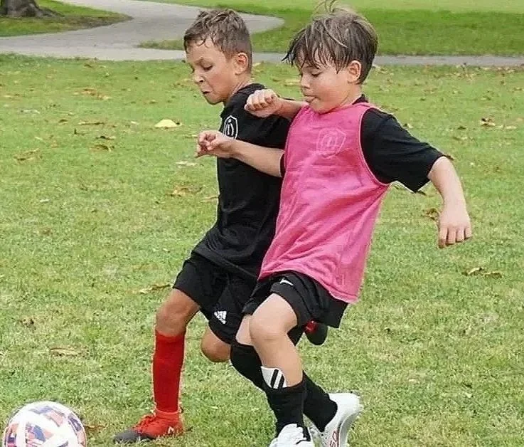 Players participating in a Top 1 Soccer Training summer soccer camp at Coral Reef Park