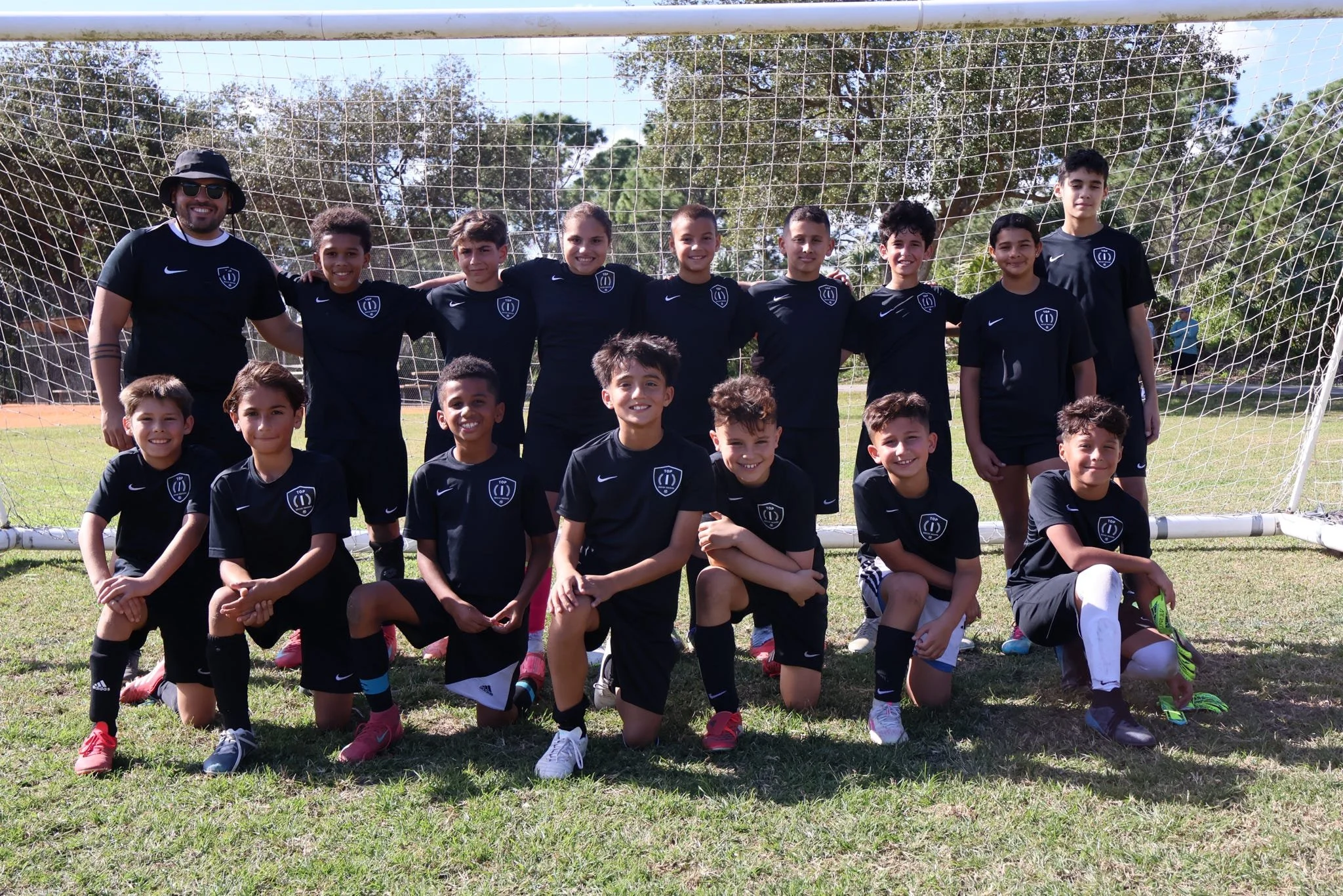 Players and coaches participating in the Top 1 Soccer Training winter soccer camp at Coral Reef Park in Miami, Florida.