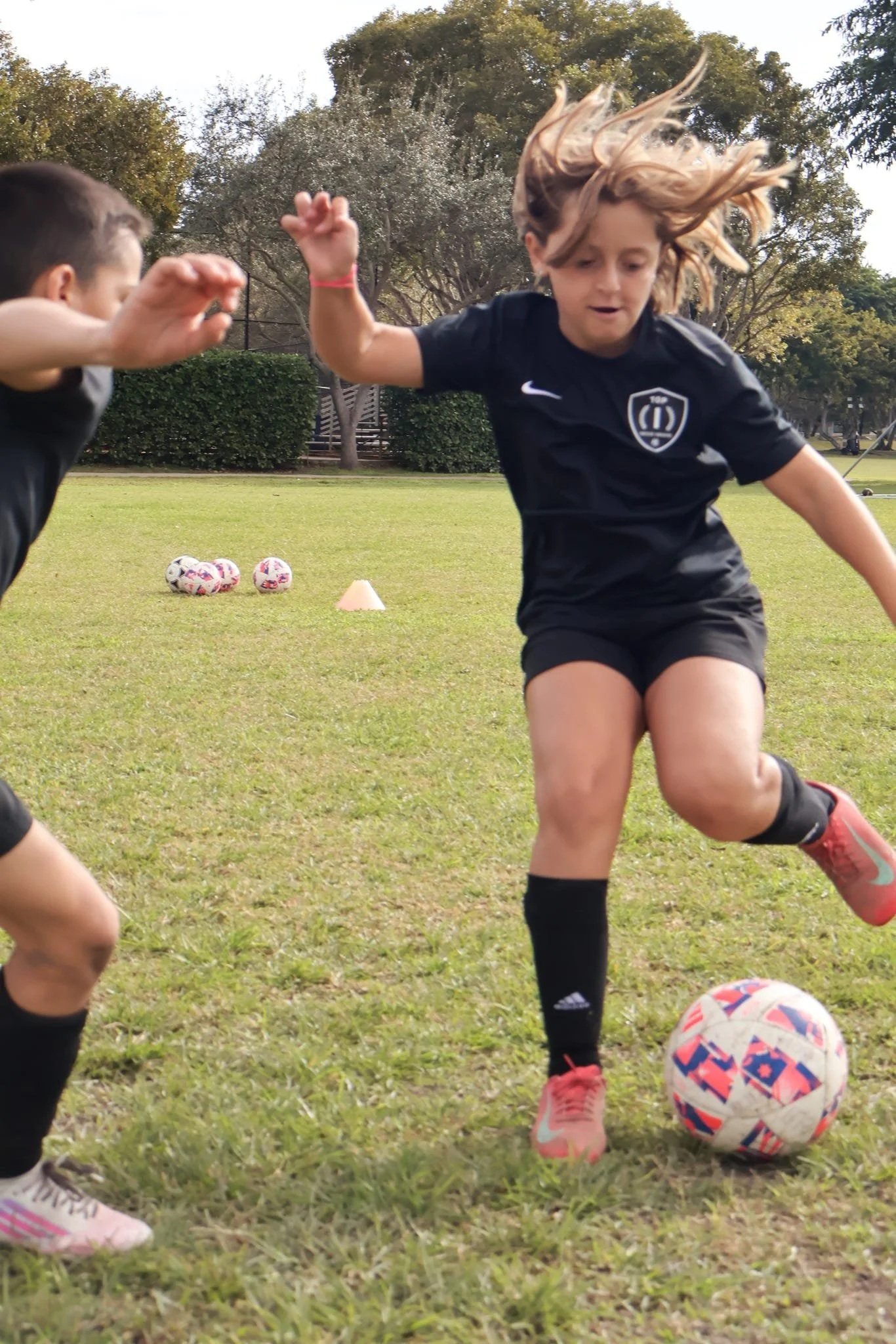 Youth athletes developing technical skills during a Top 1 Soccer Training clinic