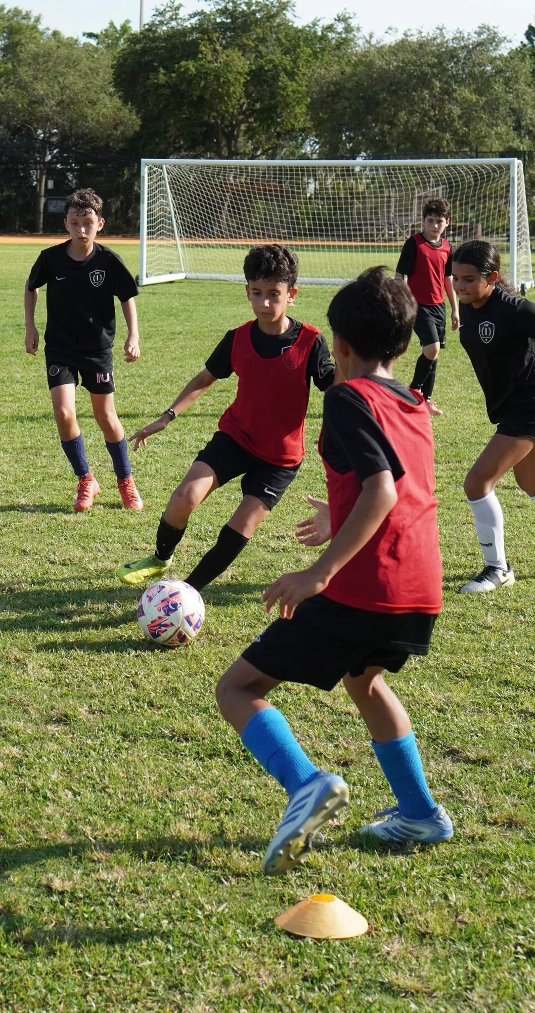 Players participating in a Top 1 Soccer Training summer soccer camp at Coral Reef Park