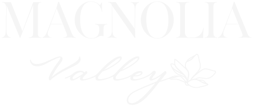 Magnolia Valley logo with stylized text and a leaf illustration.
