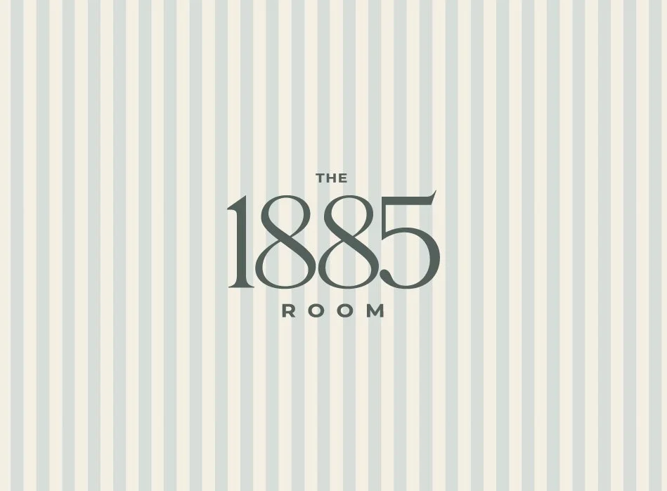 Logo for The 1885 Room with a striped background.