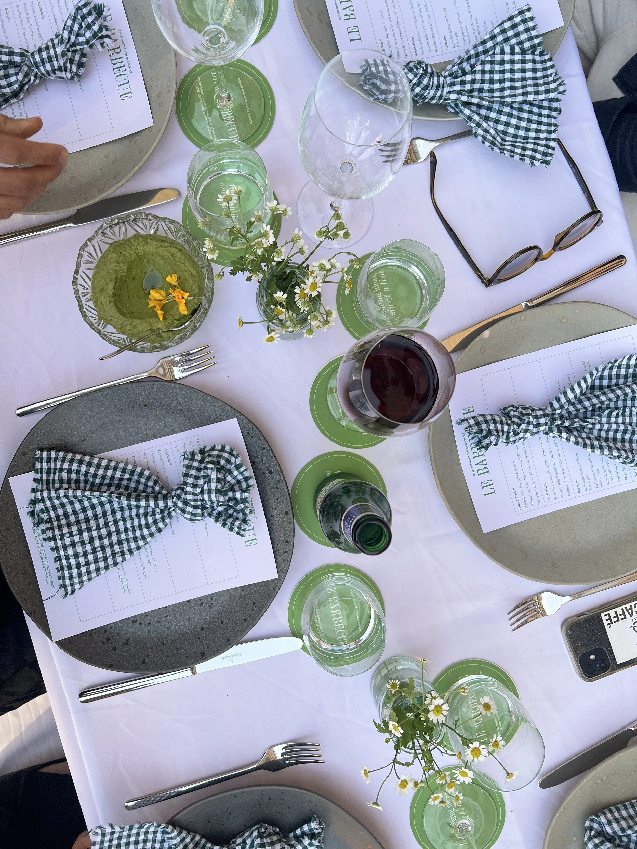 Dinner party table setting featuring green accents