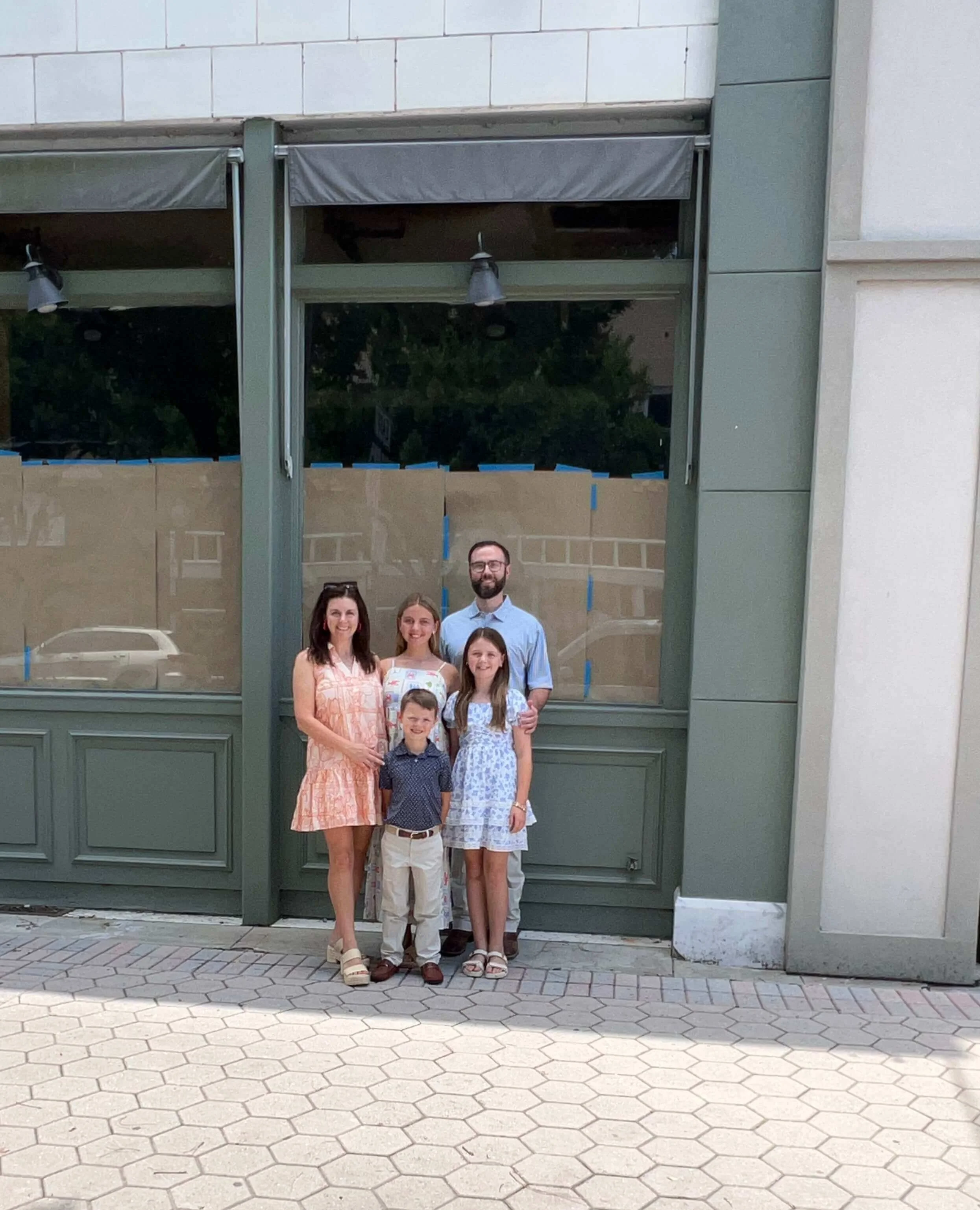 The Davis family in front of the Society House storefront in Valdosta, Georgia while construction is underway.