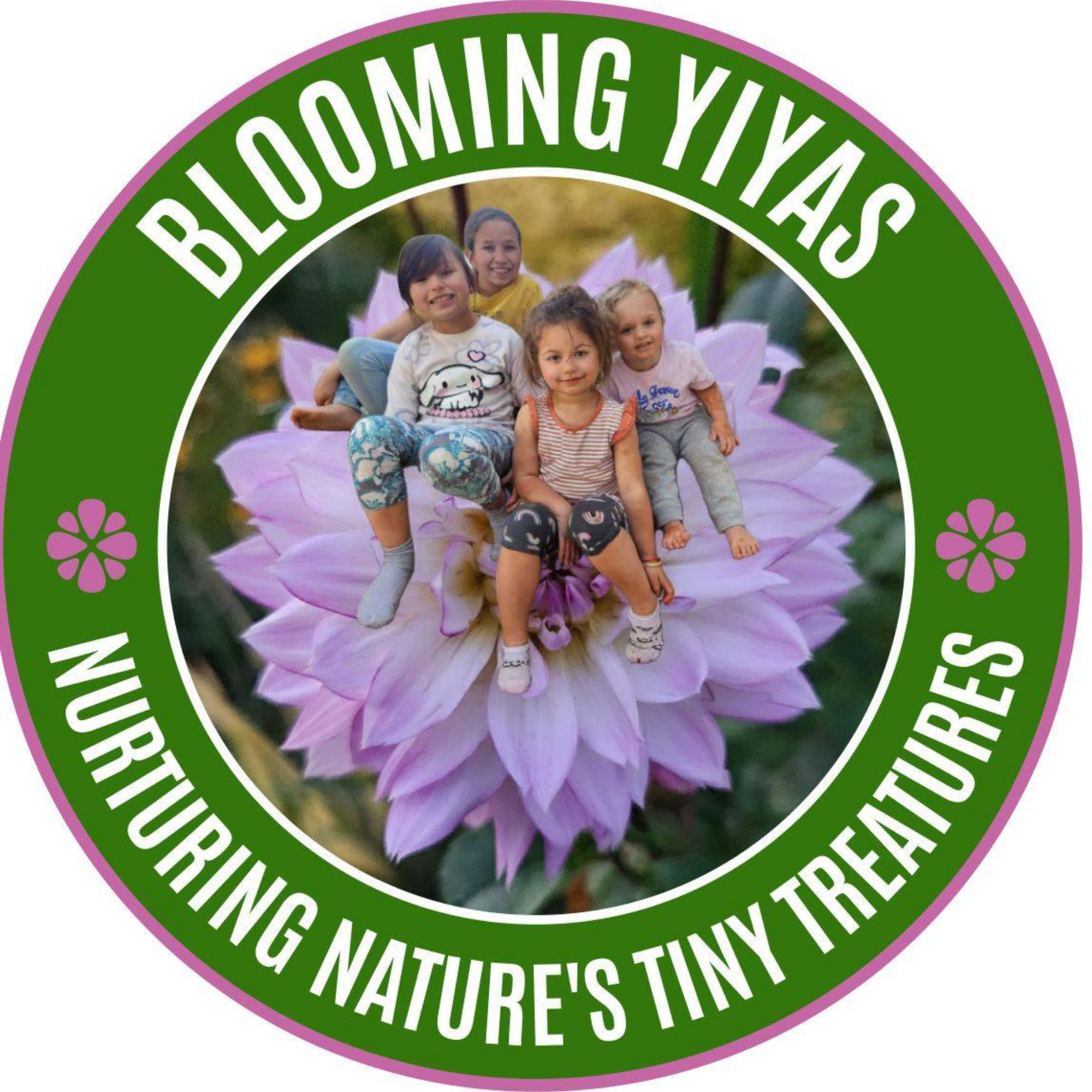 Children sitting on a large pink flower in a park with green trees in the background.