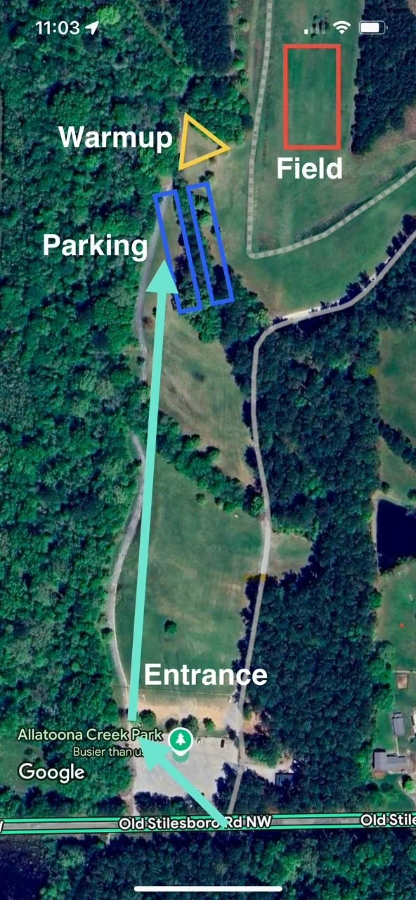 Map showing the layout of Allatoona Creek Park with designated areas labeled for entrance, parking, warmup, and field, along with pathways connecting each area.
