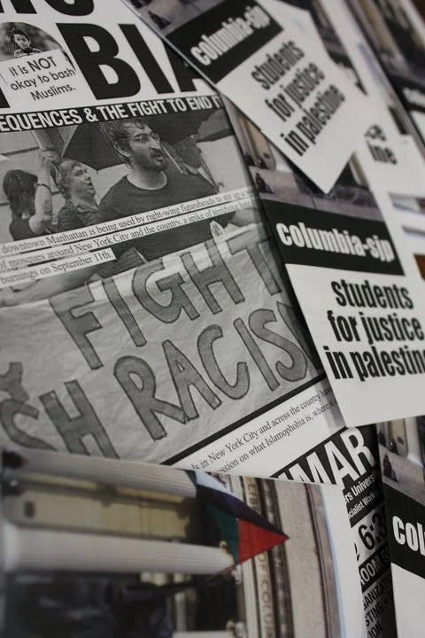 Collection of protest flyers and newspapers with headlines like "Fight Racism" and "Students for justice in Palestine."