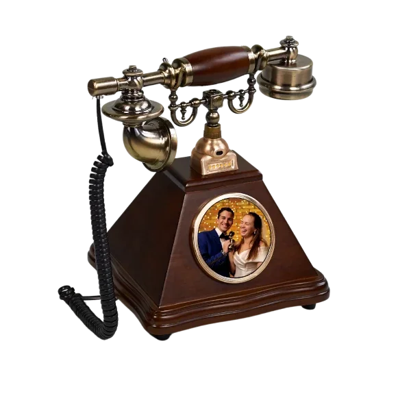 Vintage telephone with a digital photo frame in the base, displaying a couple.