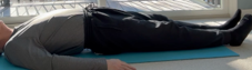 Person lying on a yoga mat in a peaceful pose
