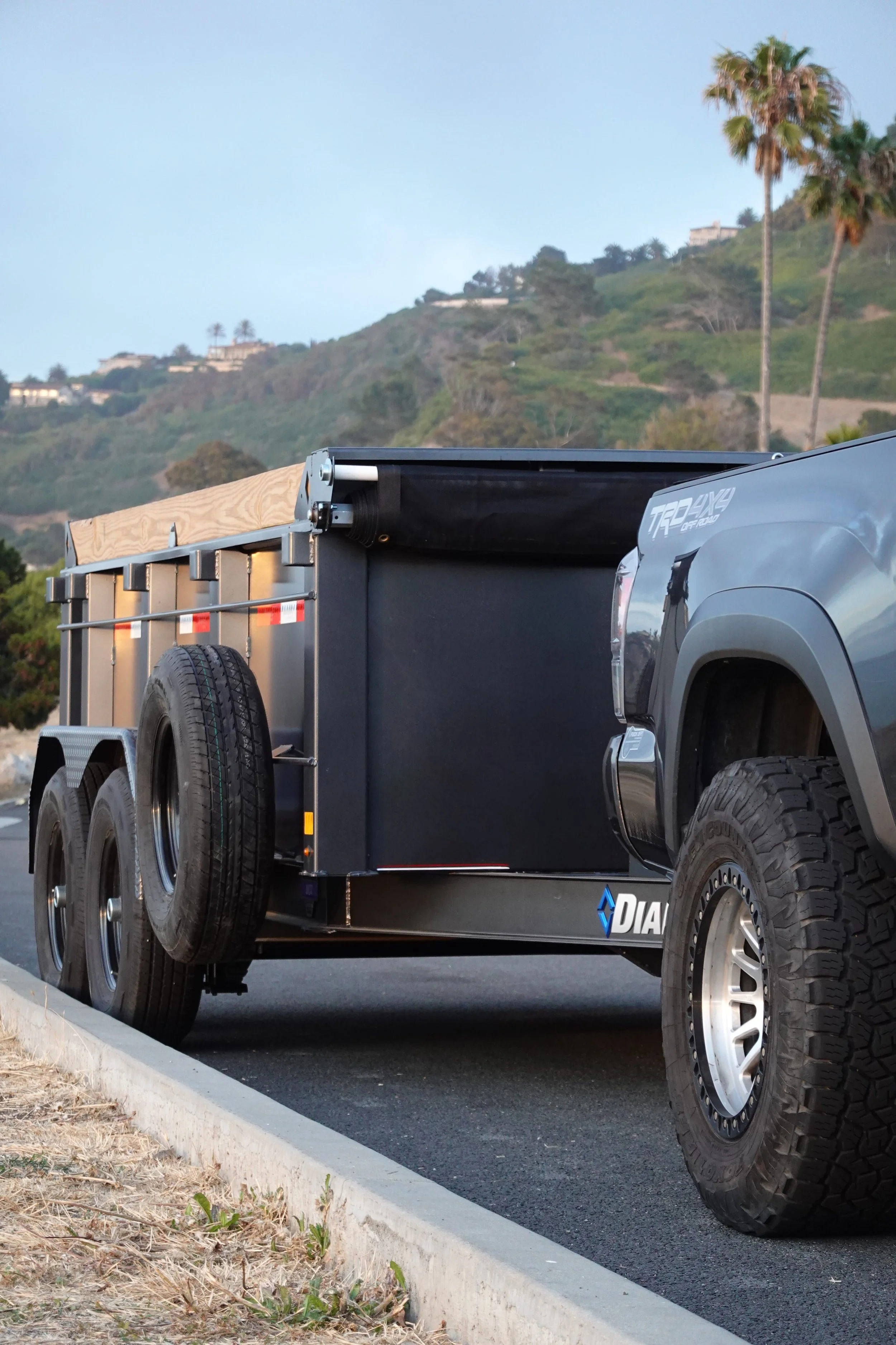 A commercial junk removal trailer parked on the side of a South Bay road ready for driveway dumpster drop-off or waste pickup.