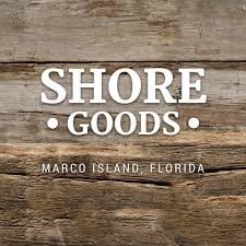 Sign with the text STORE GOODS, MARCO ISLAND, FLORIDA, on a wooden background