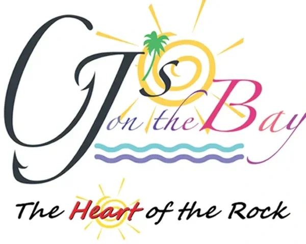 Logo with stylized text reading 'G on the Bay, The Heart of the Rock' with sun, wave, palm tree, and dolphin graphics.