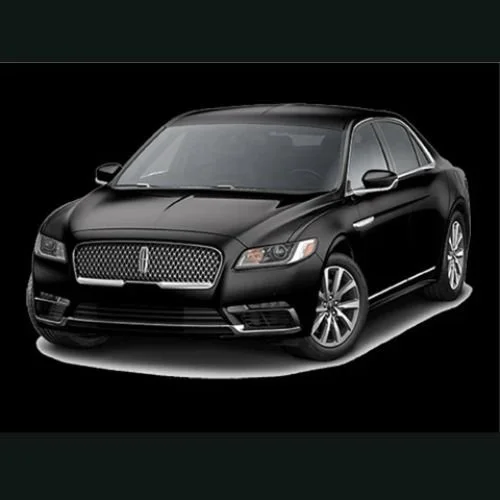 Black sedan car with a sleek design on a black background.