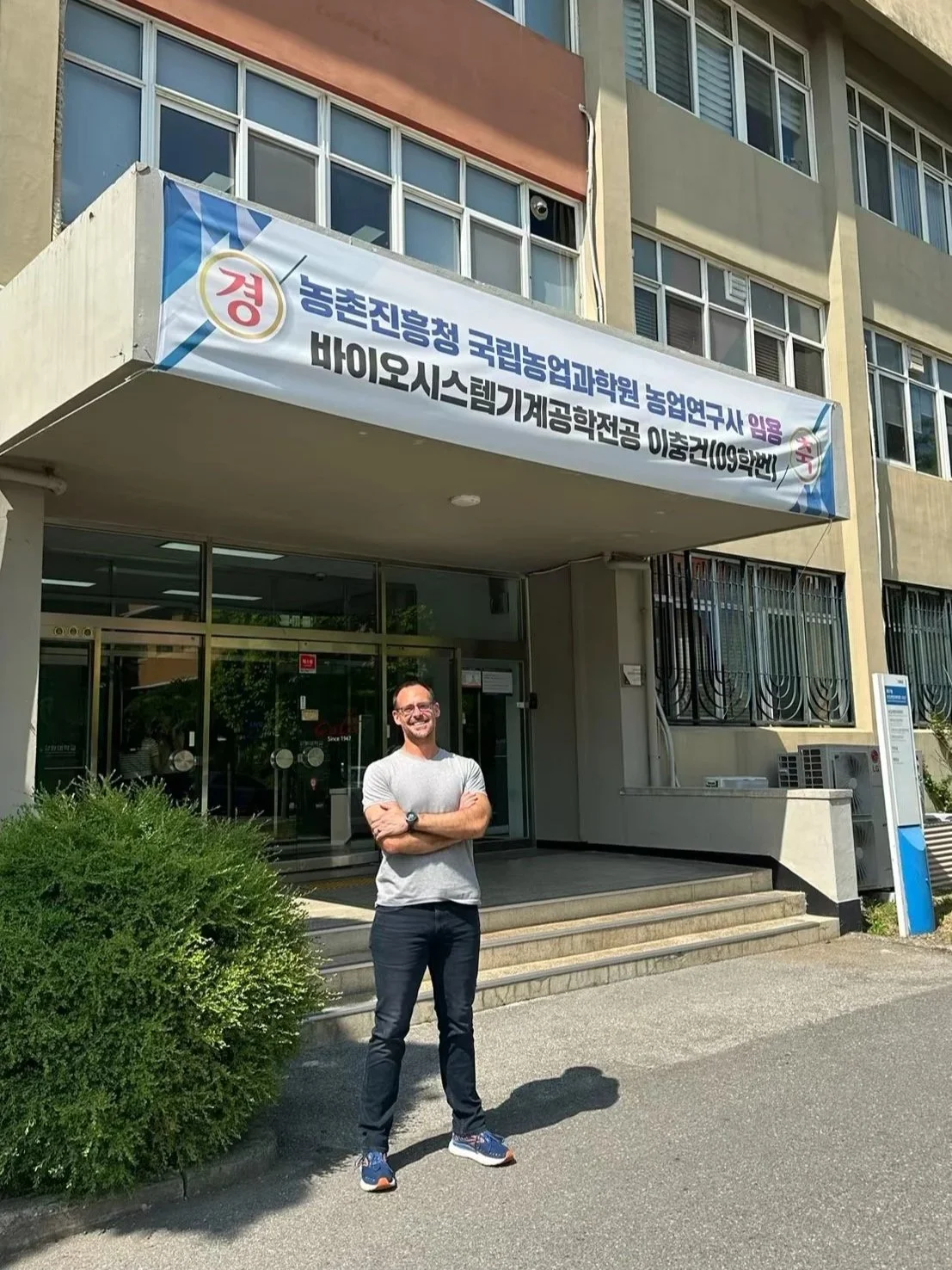 Dr. K. Aleks Schaefer standing in front of a building in South Korea.