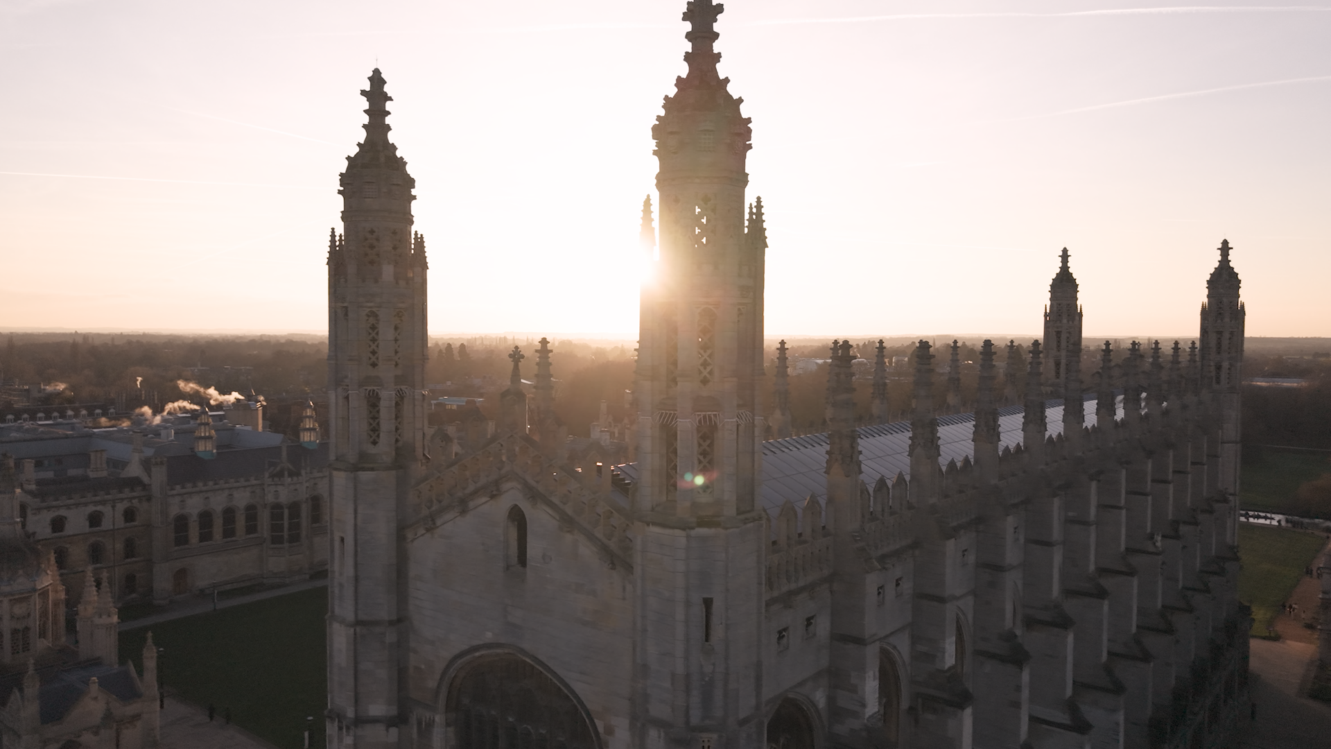 Sunlight shines through the spires of a historic building at Cambridge University