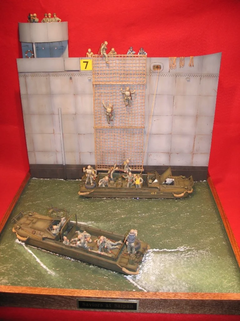 Miniature diorama of soldiers and boats on water, depicting a rescue scene at Salpan with soldiers climbing a wall to aid others