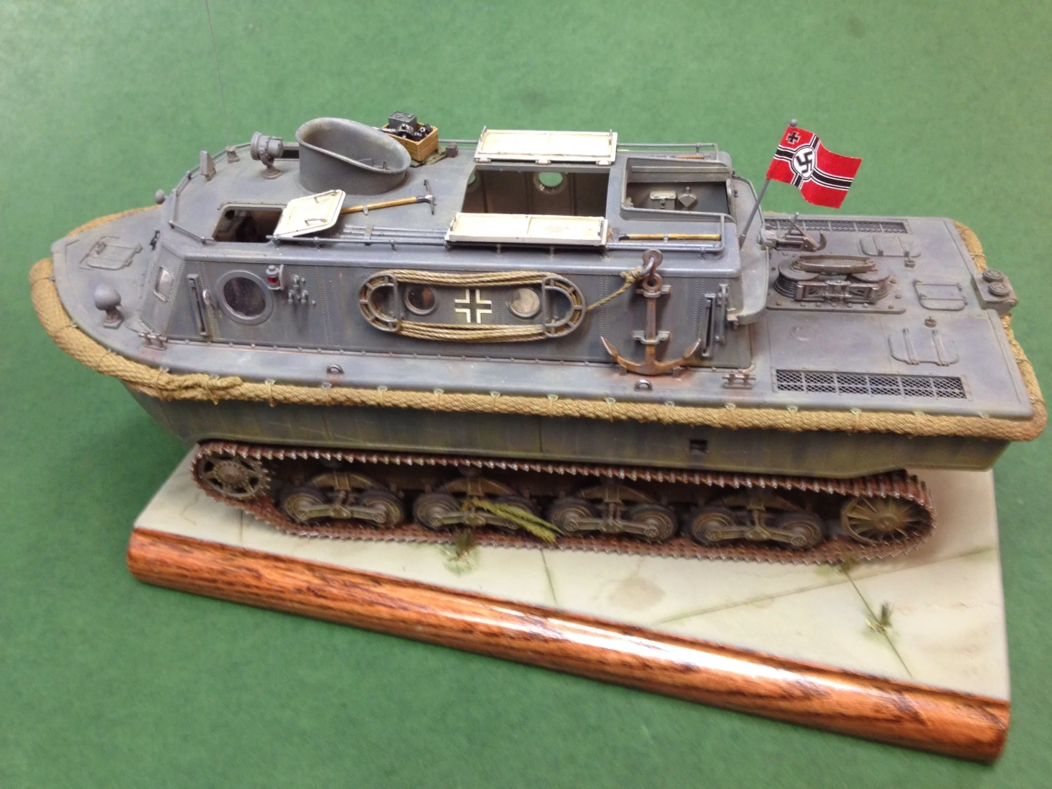 A detailed model of a World War II German amphibious tank with a rope fenders.
