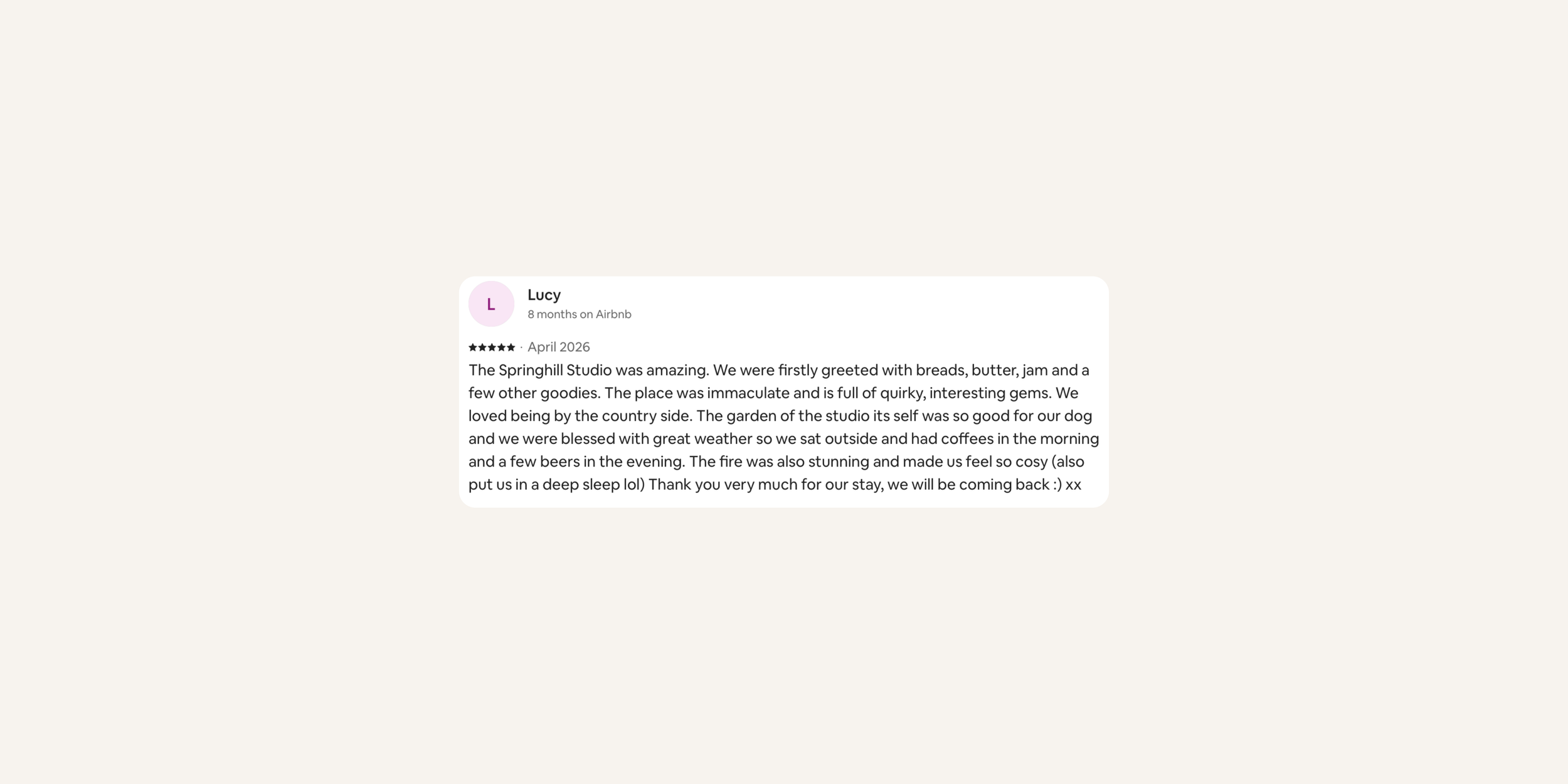 A screenshot of an Airbnb review with a five-star rating from Lucy about her stay at Springhill Studio in April 2026, describing the experience and amenities.