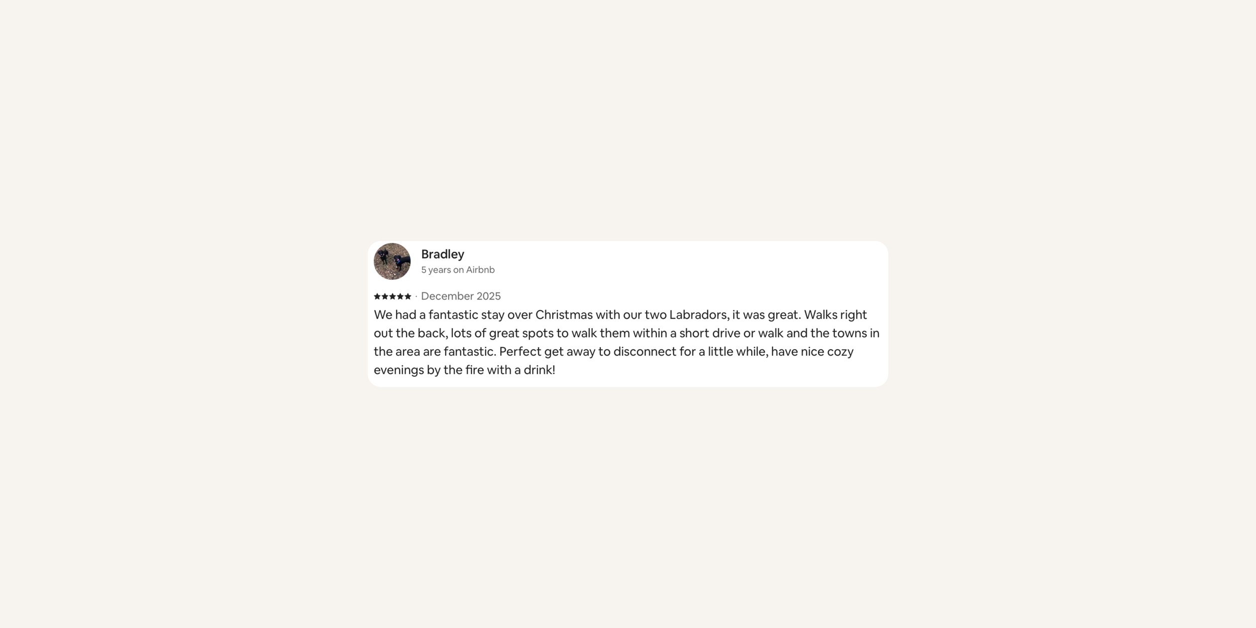 A screenshot of a positive Airbnb review from Bradley about a stay with two Labrador dogs during Christmas, describing the outdoor surroundings and activities.