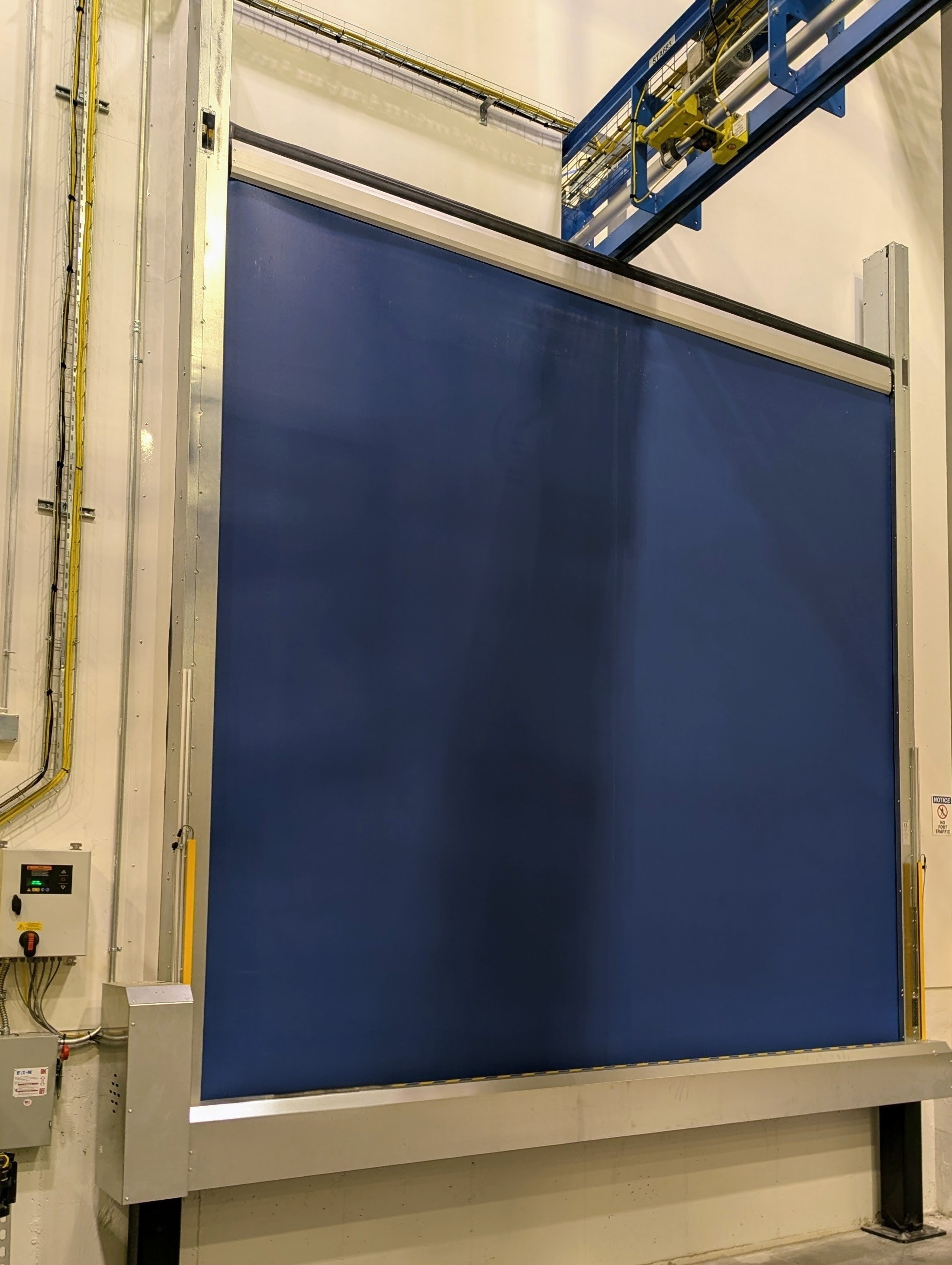 Inverted high-speed rolling door in an automated powder-coating production line