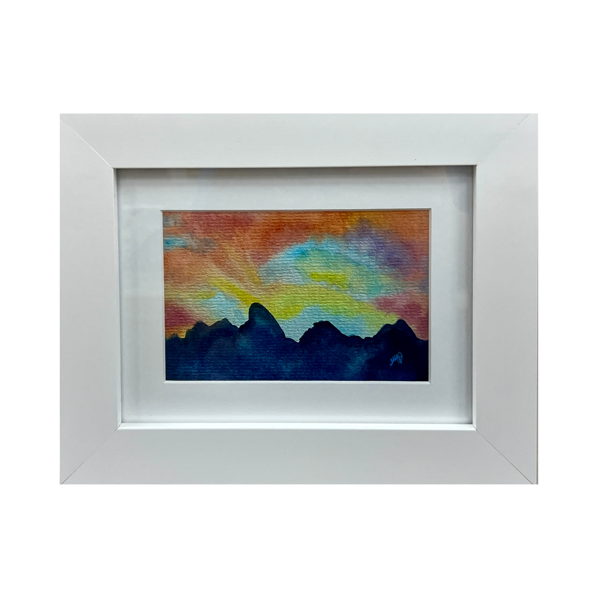Framed painting of a colorful sunset over mountains with vibrant colors and textured brushstrokes.