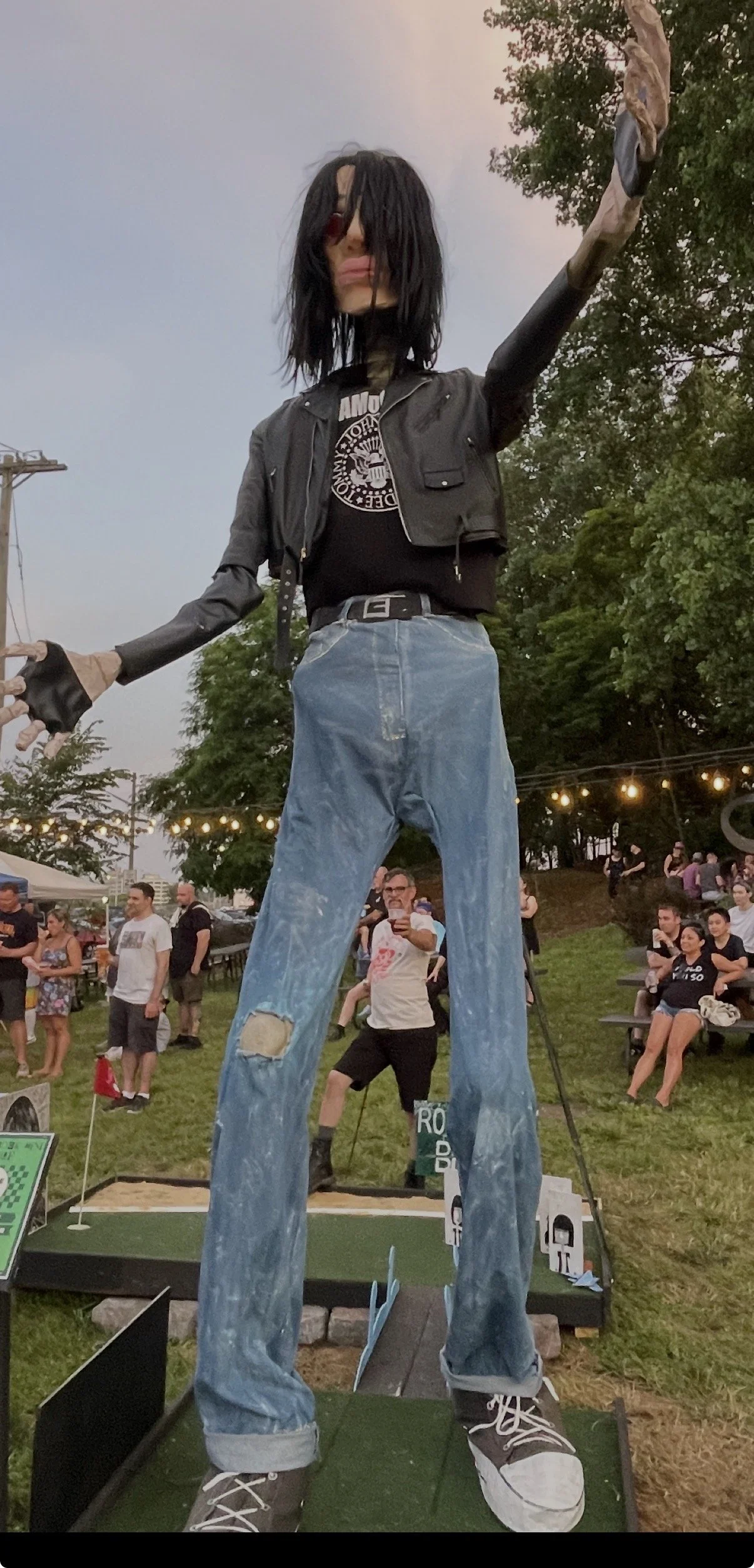 Giant sculpted Joey Ramone head, spray foam, Cosplay clay, masking tape, acrylic, on a 12' skeleton head, (Body/clothes by Kristin Wallace and Scott Raffo) Prop for Punk Rock Mini Golf at Maker Park Radio, SINY 2024