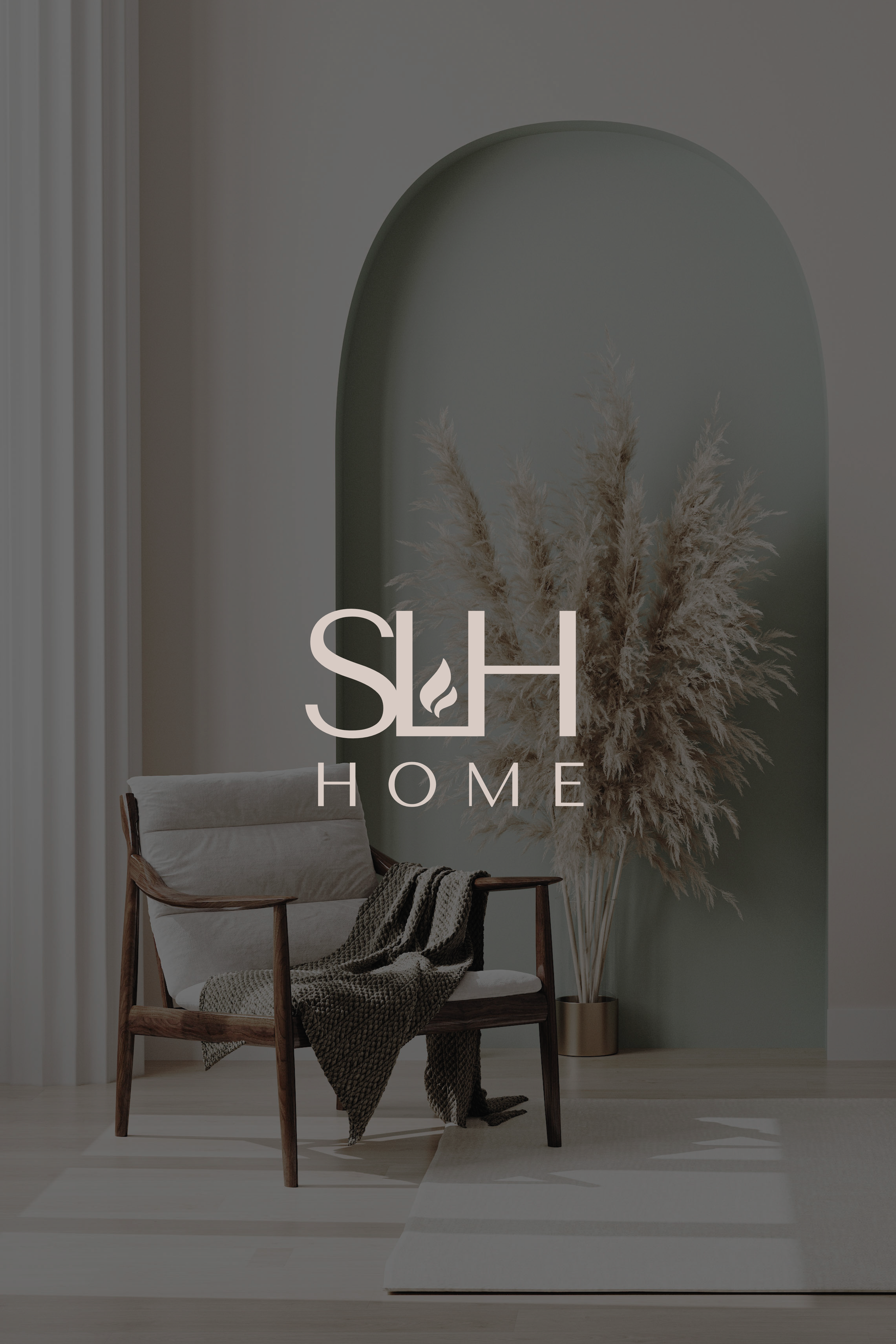 Interior room with a wooden chair draped with a knit blanket, a tall vase filled with dried pampas grass, green wall with an arched niche.