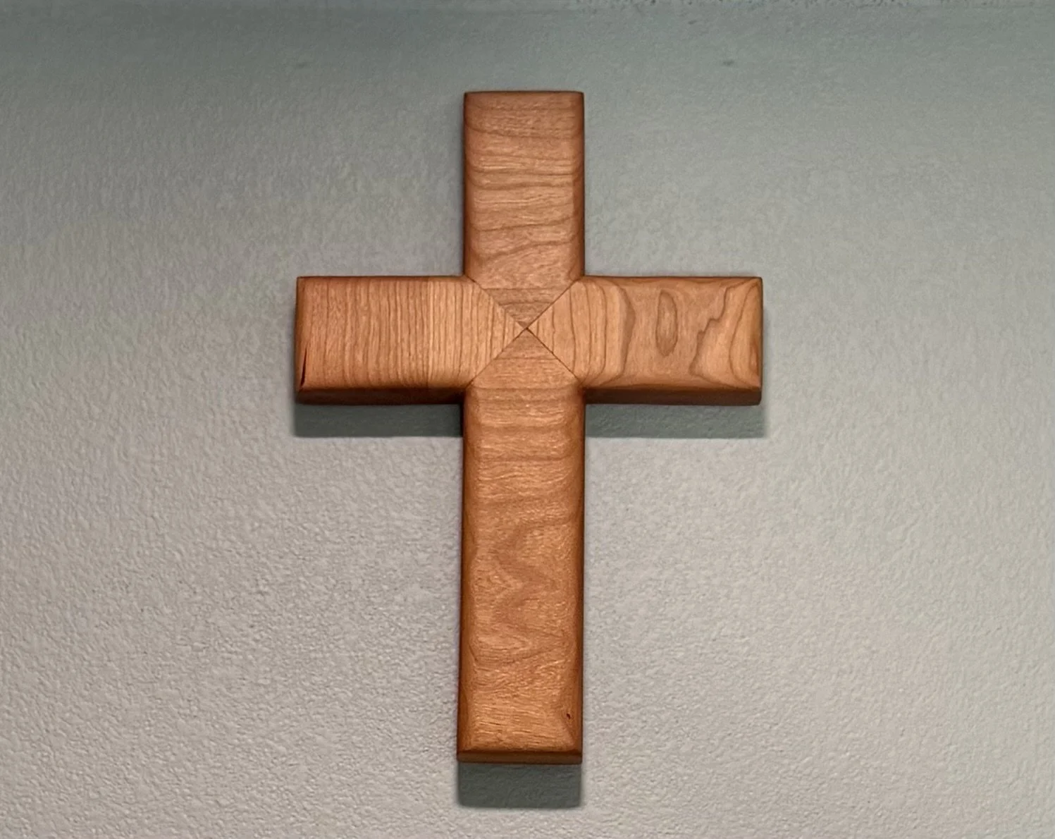 Wooden cross mounted on a wall.