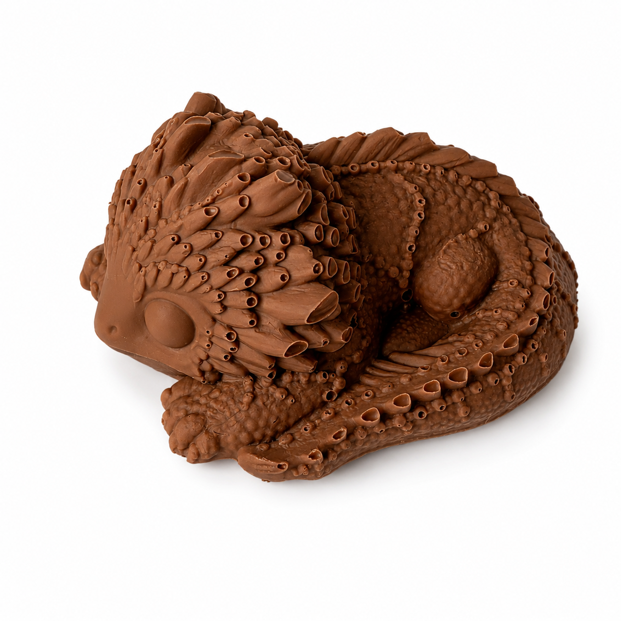 Solid Belgian milk chocolate sleeping dragon figure.