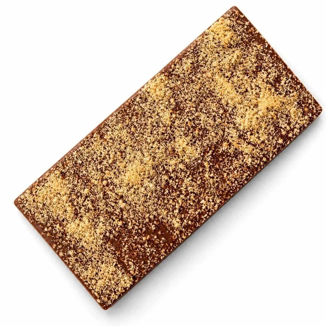 Milk chocolate rectangle covered with golden maple sugar.
