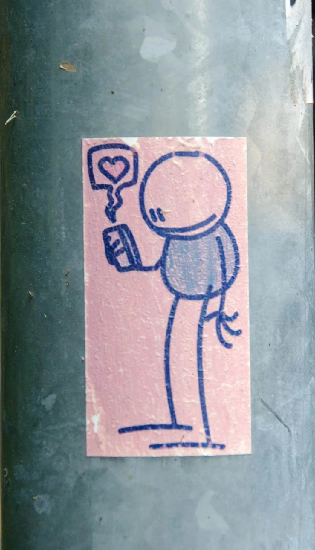 Street art illustration of a stick figure holding a phone with a speech bubble containing a heart.