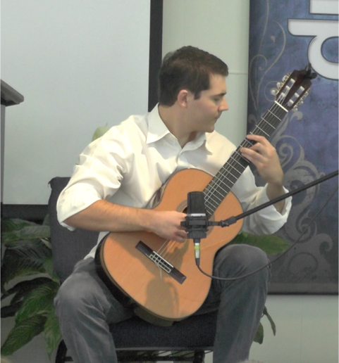 Young man playing an acoustic guitar indoors