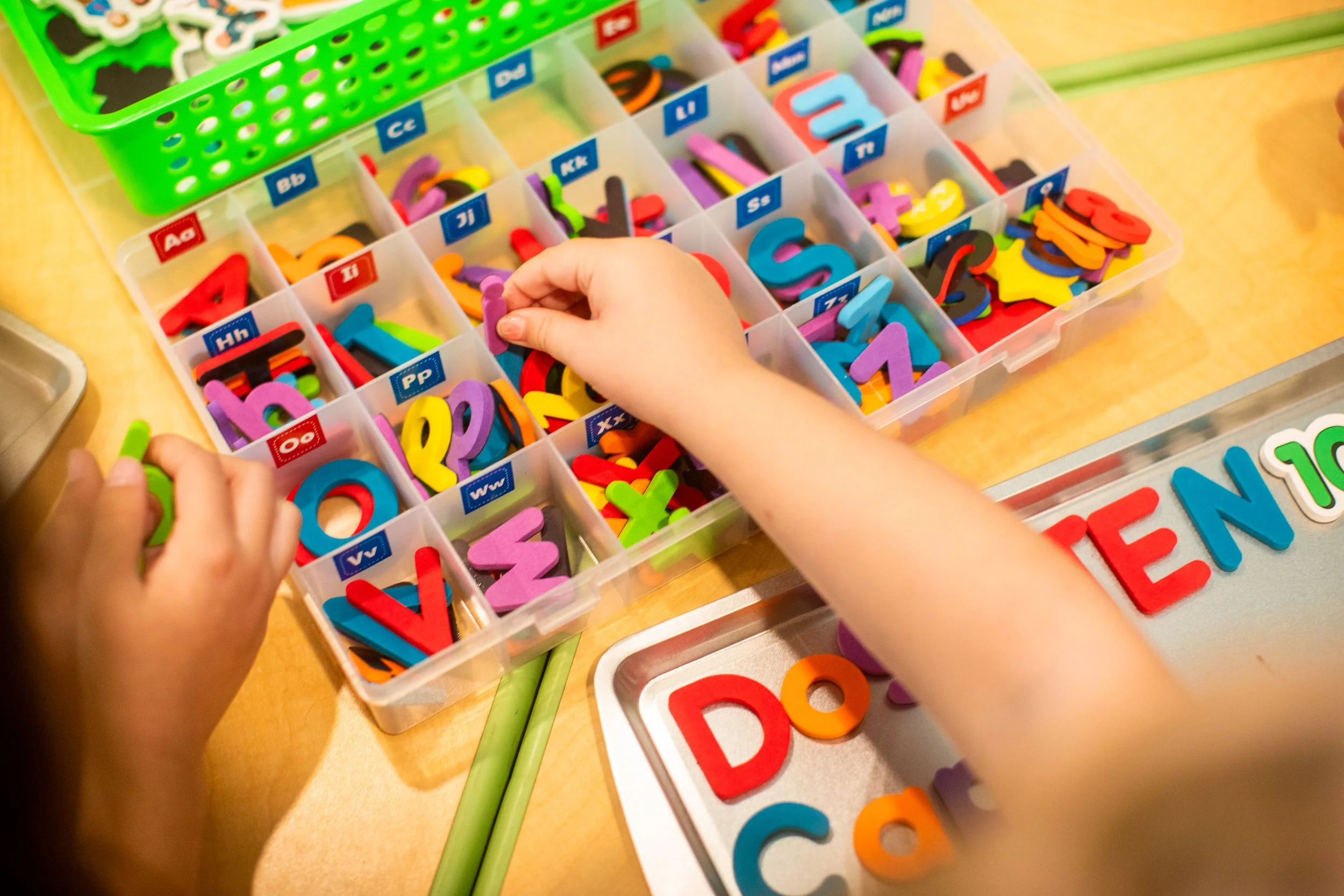 Child works on fine motor skills with letters in montessori style project