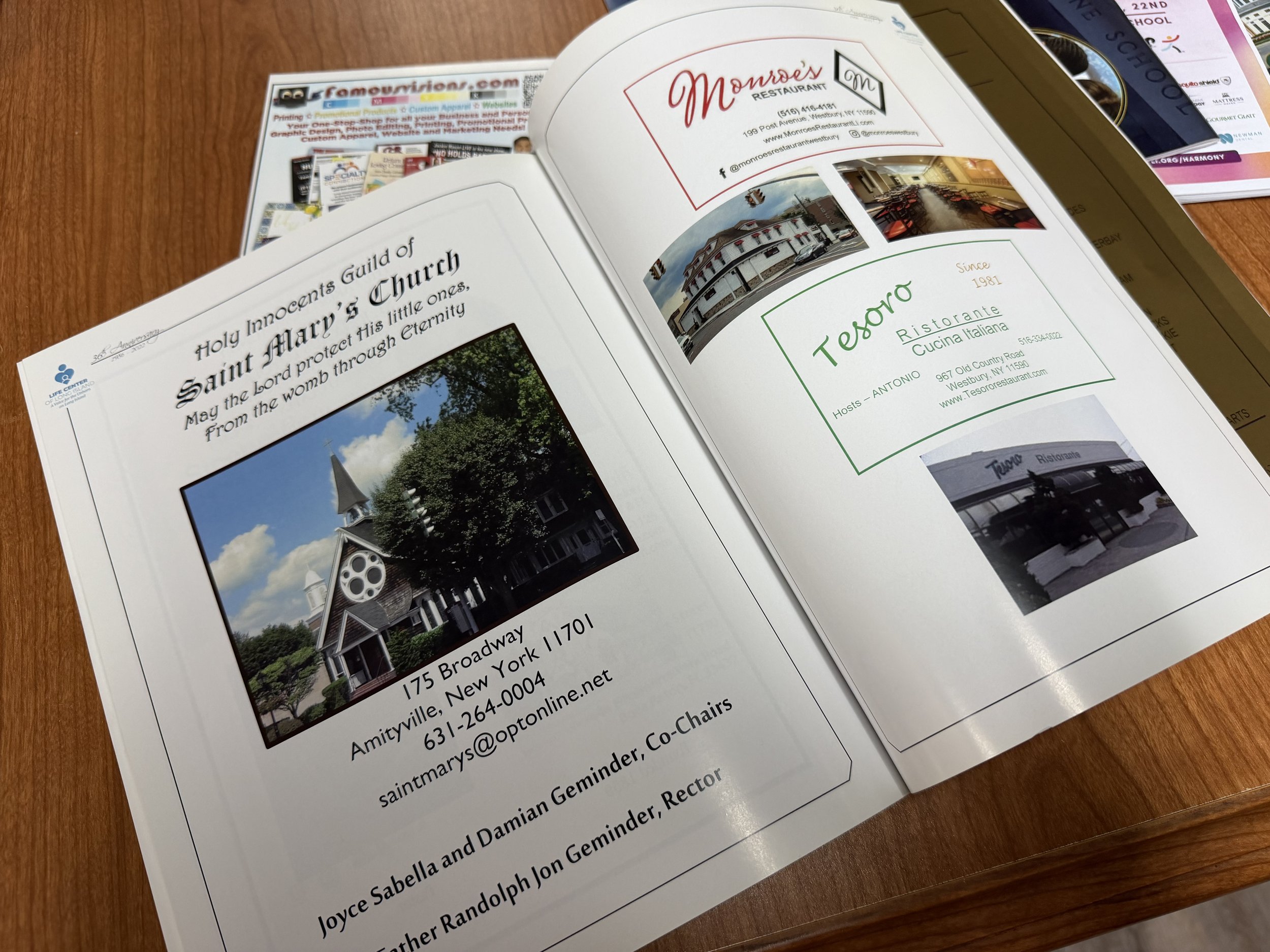 Open magazine displaying advertisements for restaurants,, with images of buildings and dining areas. 