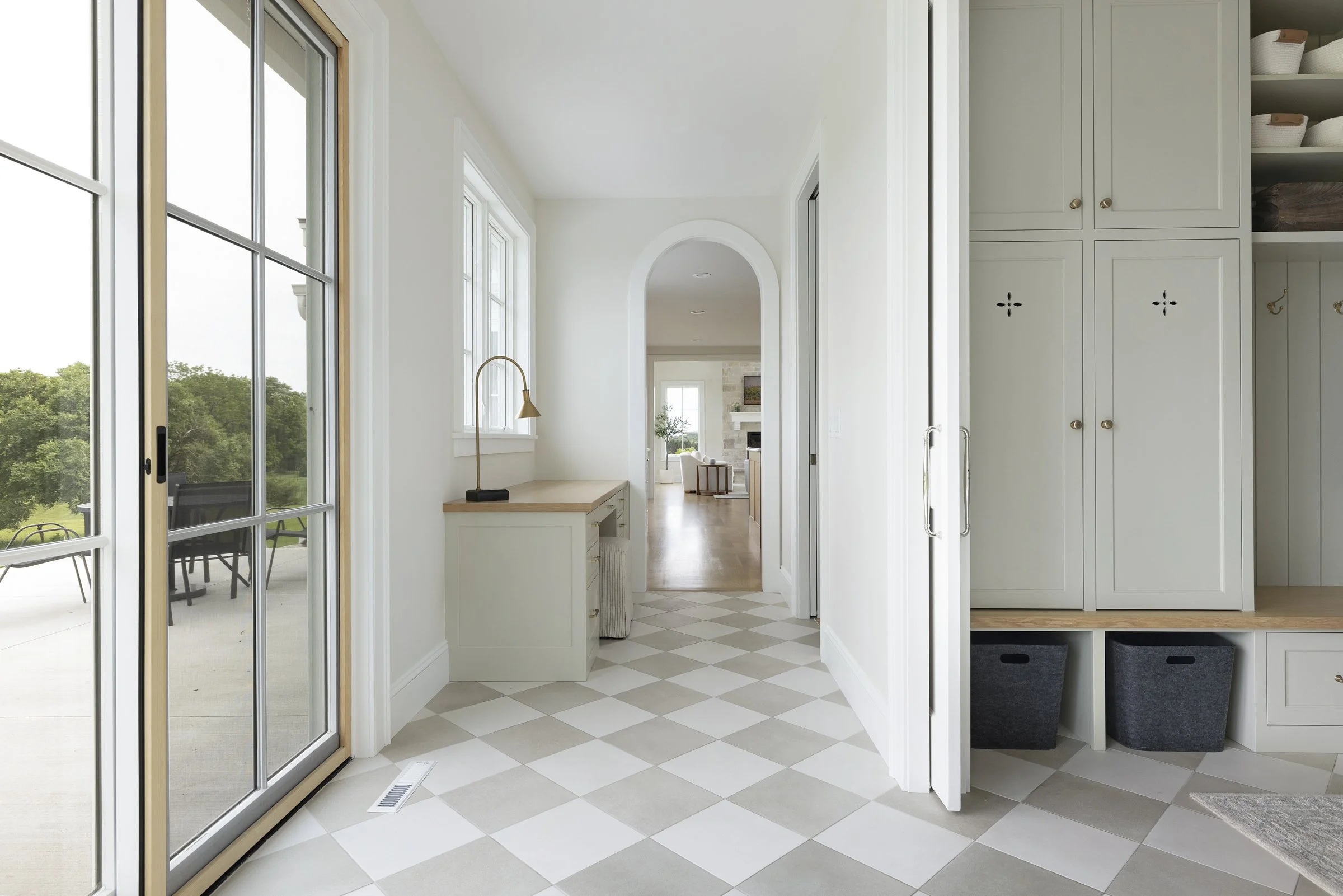 Built-in workspace and custom millwork within a light-filled mudroom in Rochester, Minnesota.