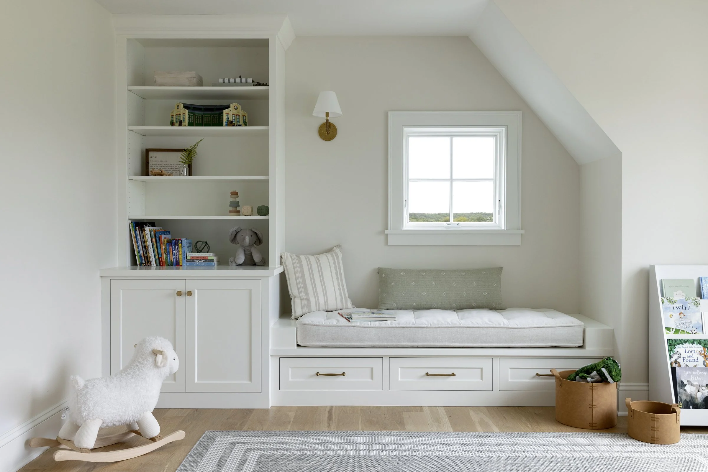 Cozy built-in window seat with integrated storage and custom shelving.