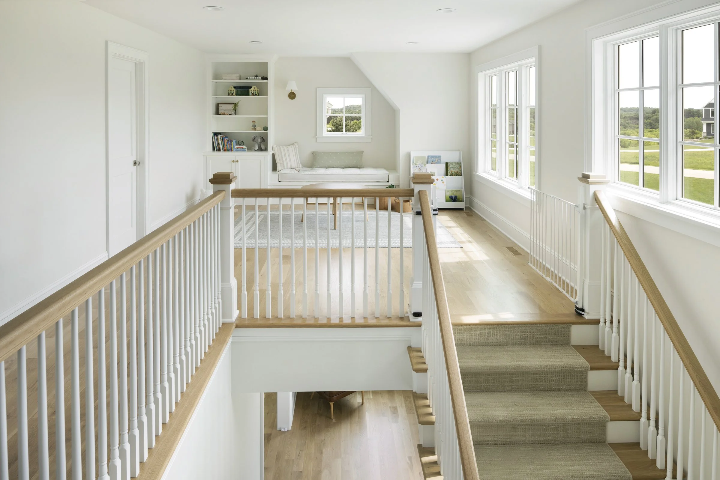 Bright second-floor loft with reading nook, built-in shelving, and natural light.