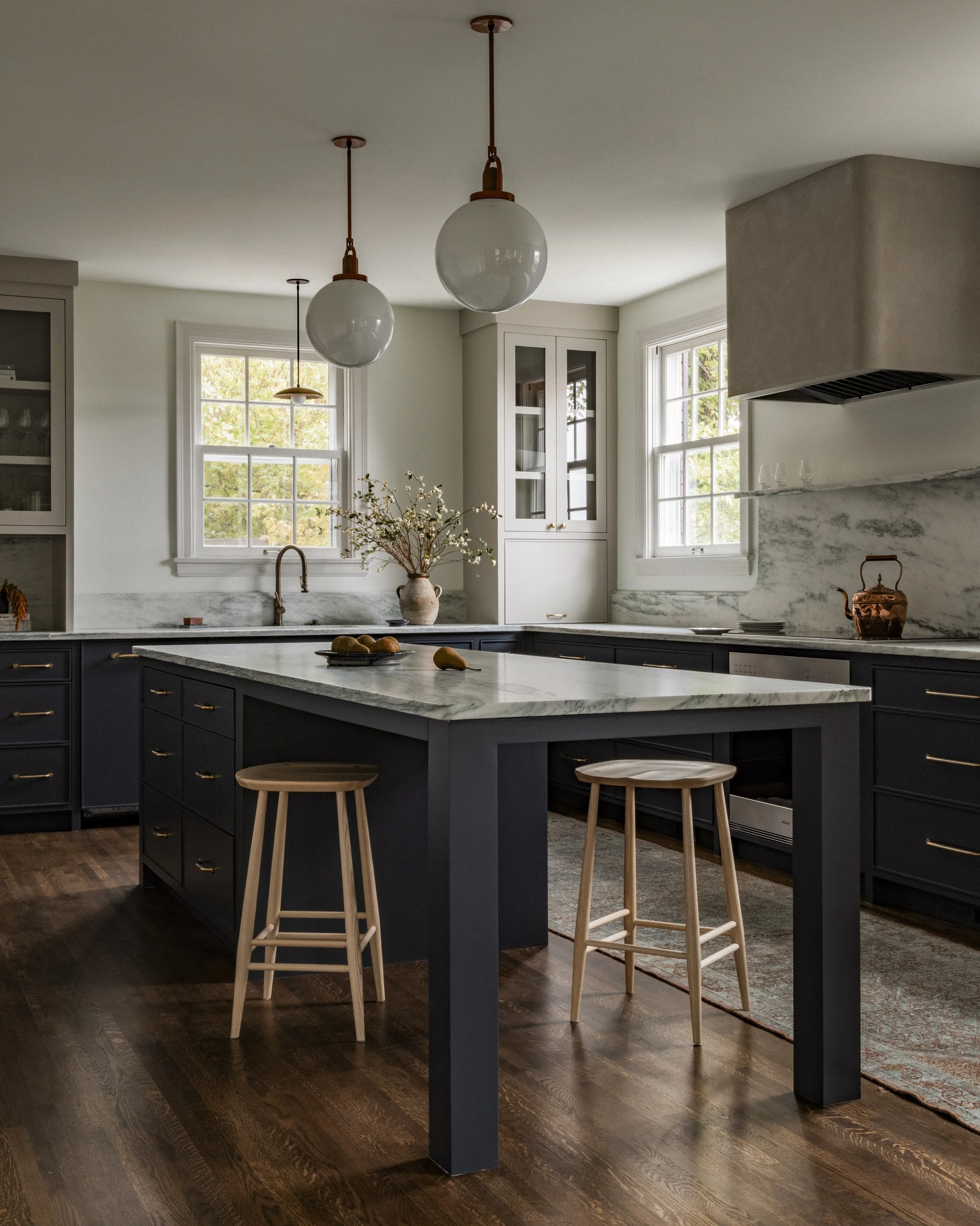 Kitchen island in a Minneapolis remodel with marble countertops, globe pendant lighting, and custom cabinetry.