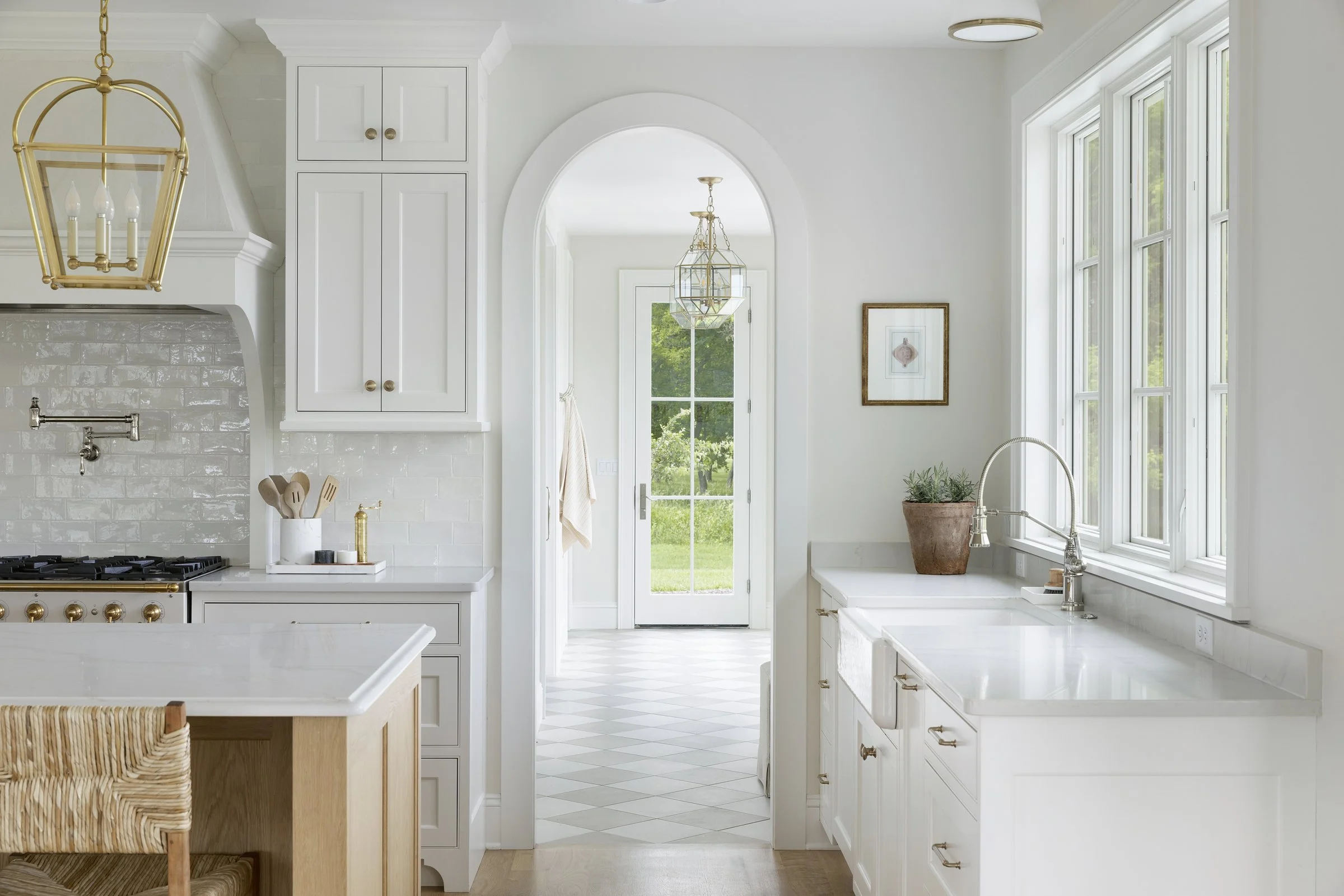 Arched architectural opening connecting living spaces in a custom Rochester, Minnesota residence.