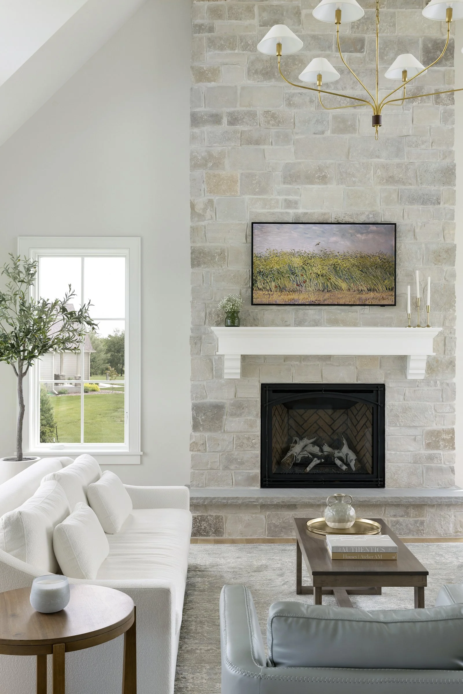 Limestone fireplace wall in the great room of a Rochester, Minnesota custom home with vaulted ceilings and abundant natural light.