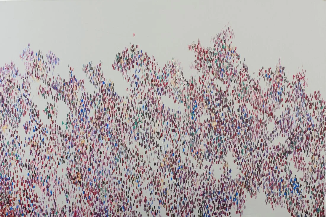 A large crowd of multicolored dots on a white background, arranged to suggest a forest of trees or a mountain range.