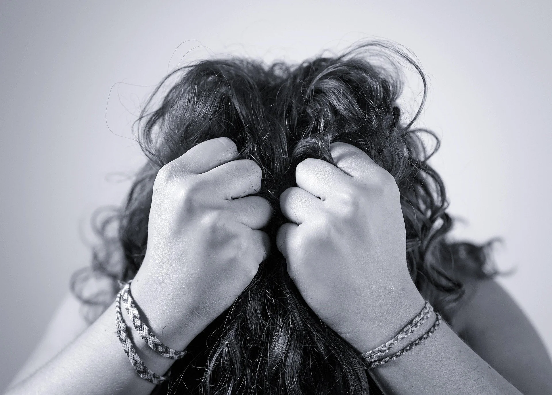 Women stressed grasping in frustration.