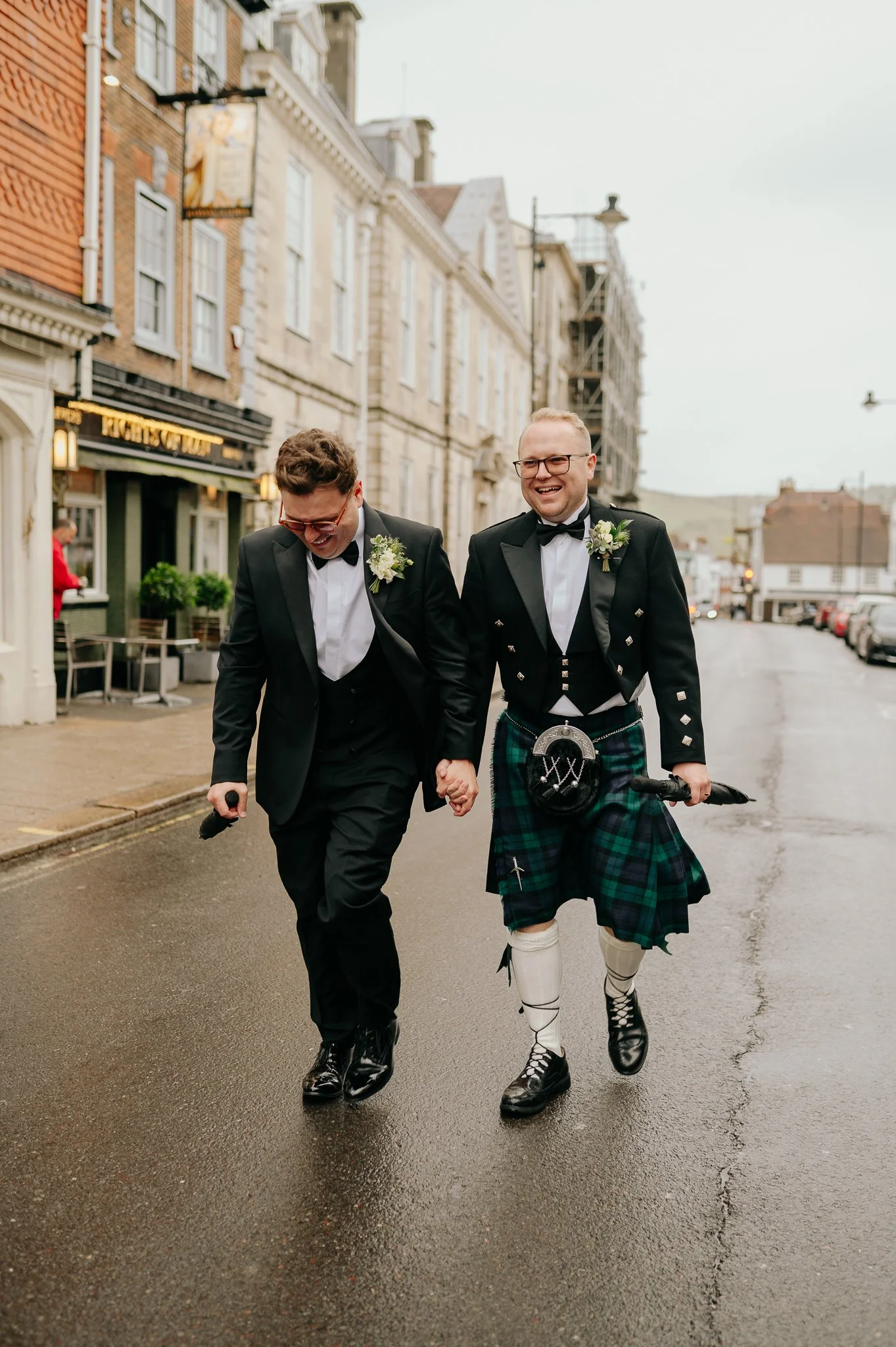 two grooms walk through lewes highstreet, East Sussex