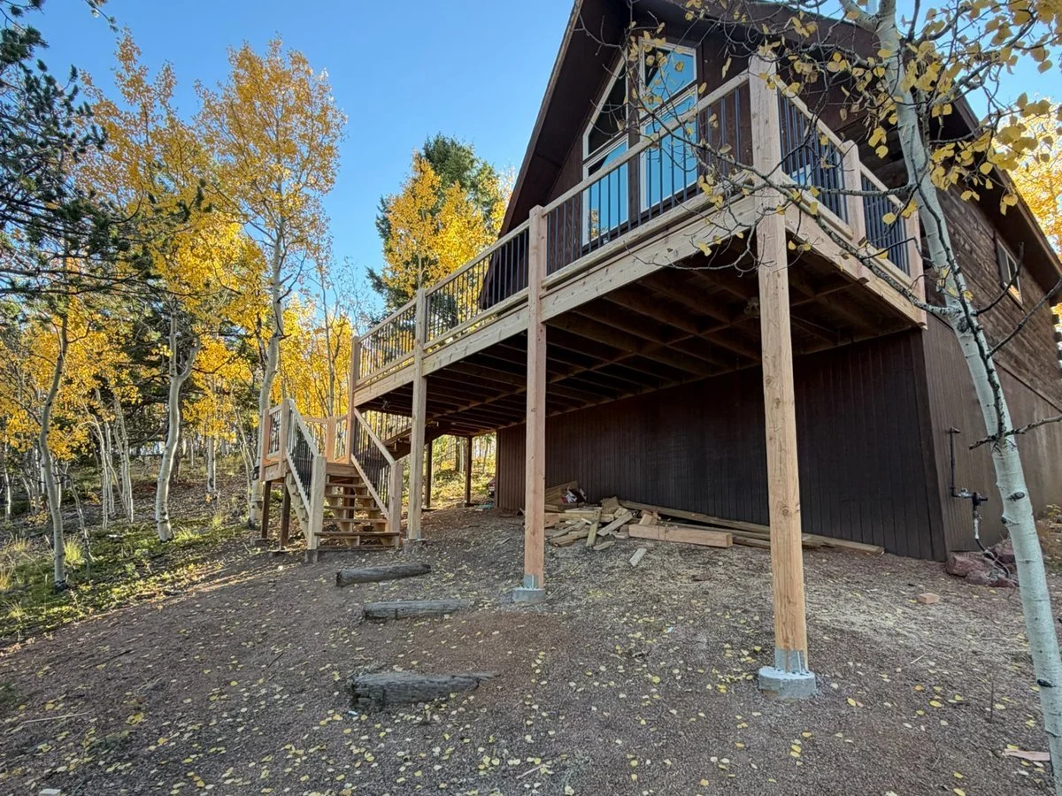 Elevated deck on an A-frame home among aspens